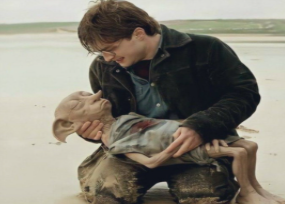 Harry holding Dobby's body.