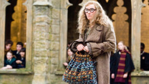 Eccentric professor holding patterned bag.
