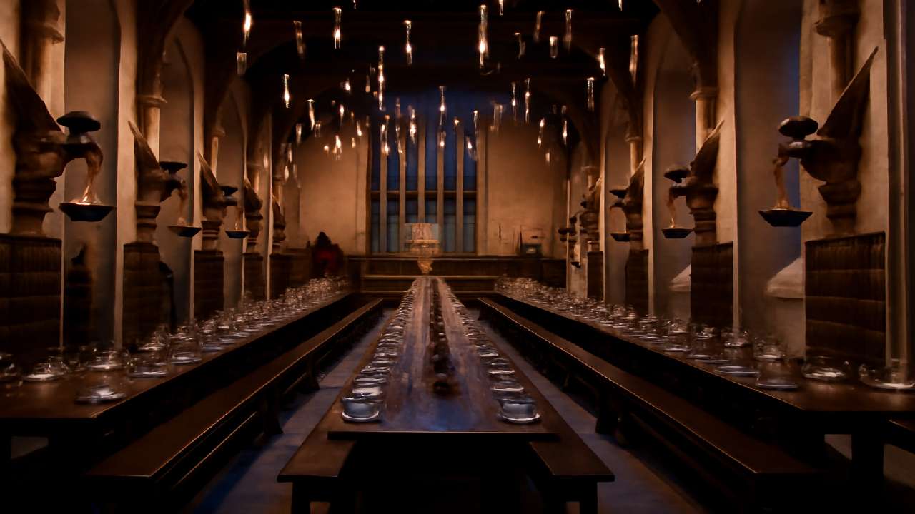 Interior of the Great Hall at Warner Bros. Studio Tour London, showcasing the iconic Harry Potter set with long wooden tables, floating candles, medieval architecture, and magical lighting, creating a captivating atmosphere for visitors.

