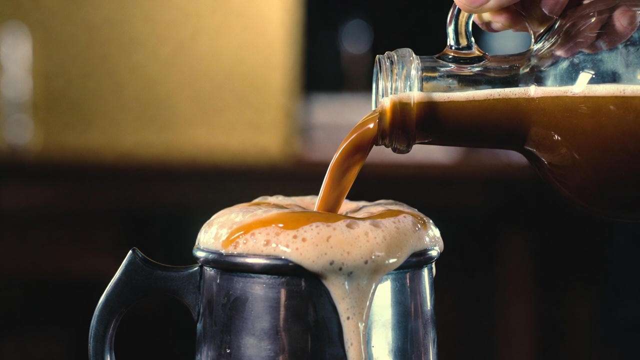 Creamy homemade butterbeer being poured in a Bloomsbury pub, 2025 