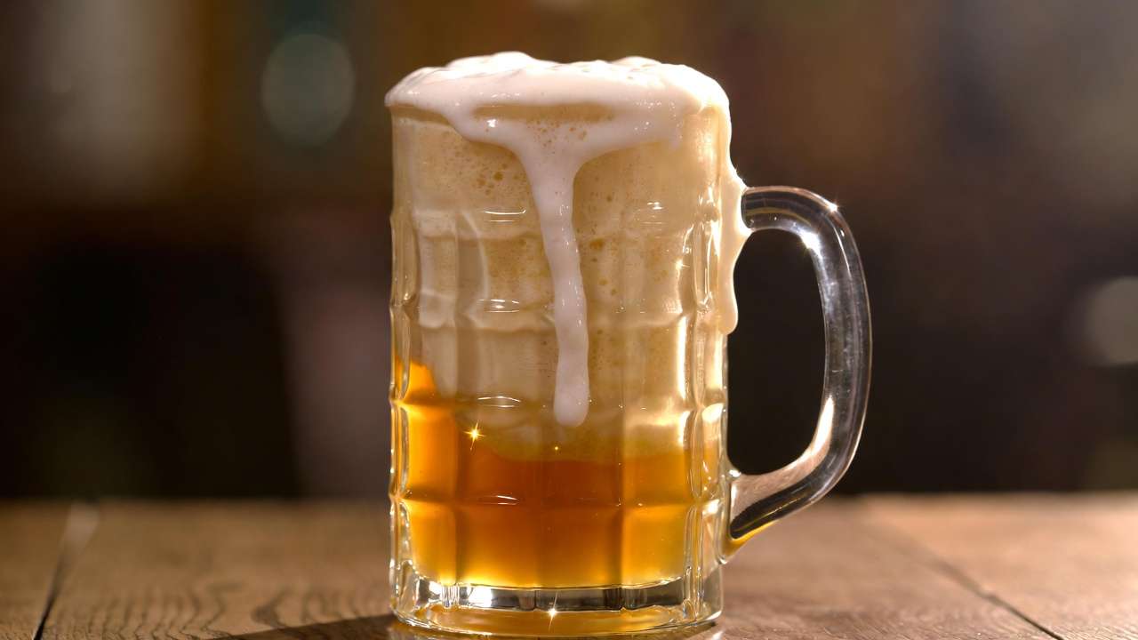 Authentic butterbeer with creamy foam in Harry Potter cafe style tankard