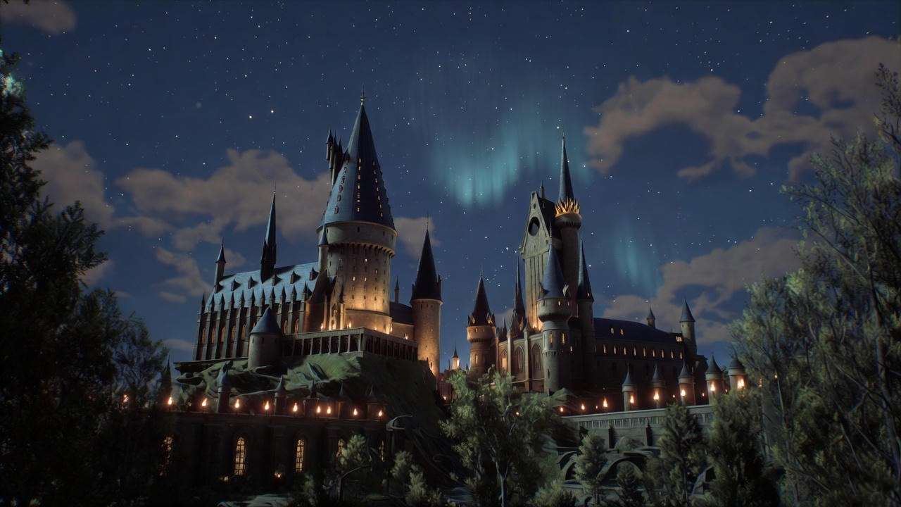 Hogwarts castle at night with glowing windows and starry sky in Hogwarts Legacy, showcasing immersive Wizarding World atmosphere