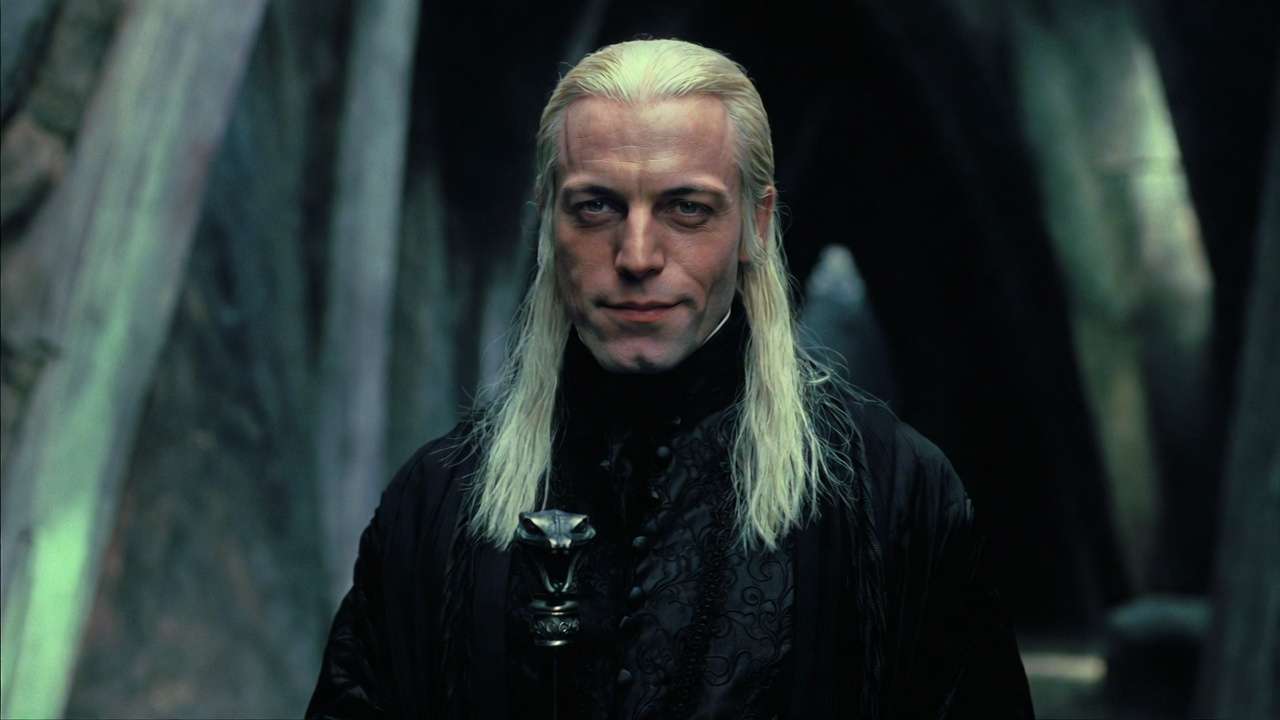 Jason Isaacs as Lucius Malfoy in Harry Potter and the Chamber of Secrets, menacing with snake cane