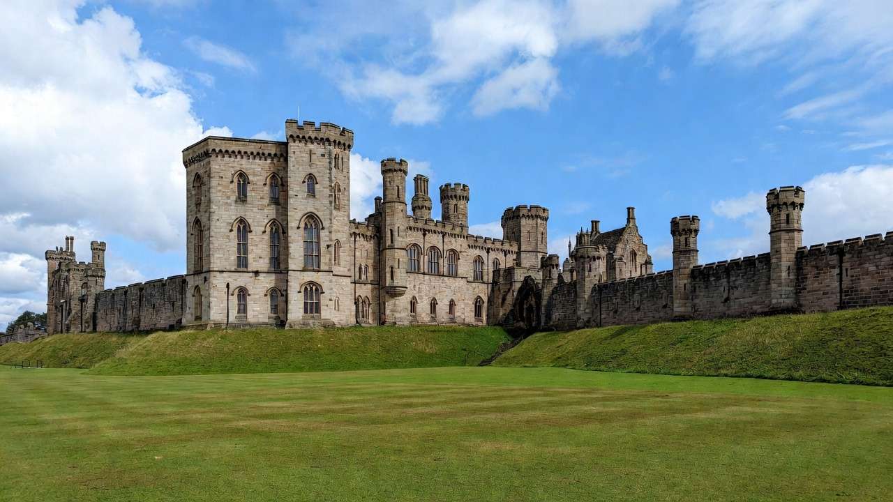 Alnwick Castle exterior Hogwarts grounds sunny medieval architecture Harry Potter scenery.